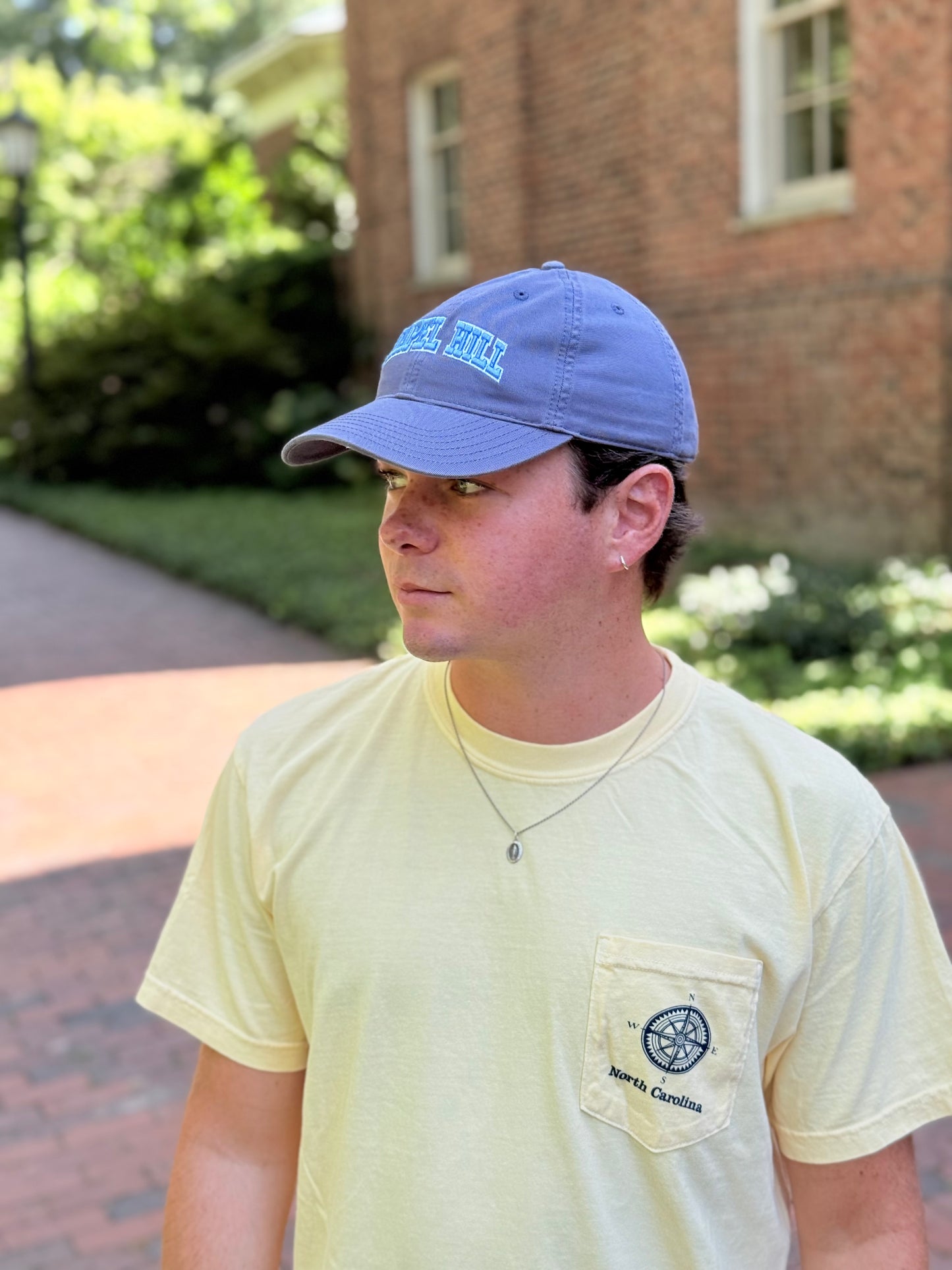 North Carolina State Coastal T-Shirt With Pocket in Butter Yellow - Lifestyle View - Shrunken Head