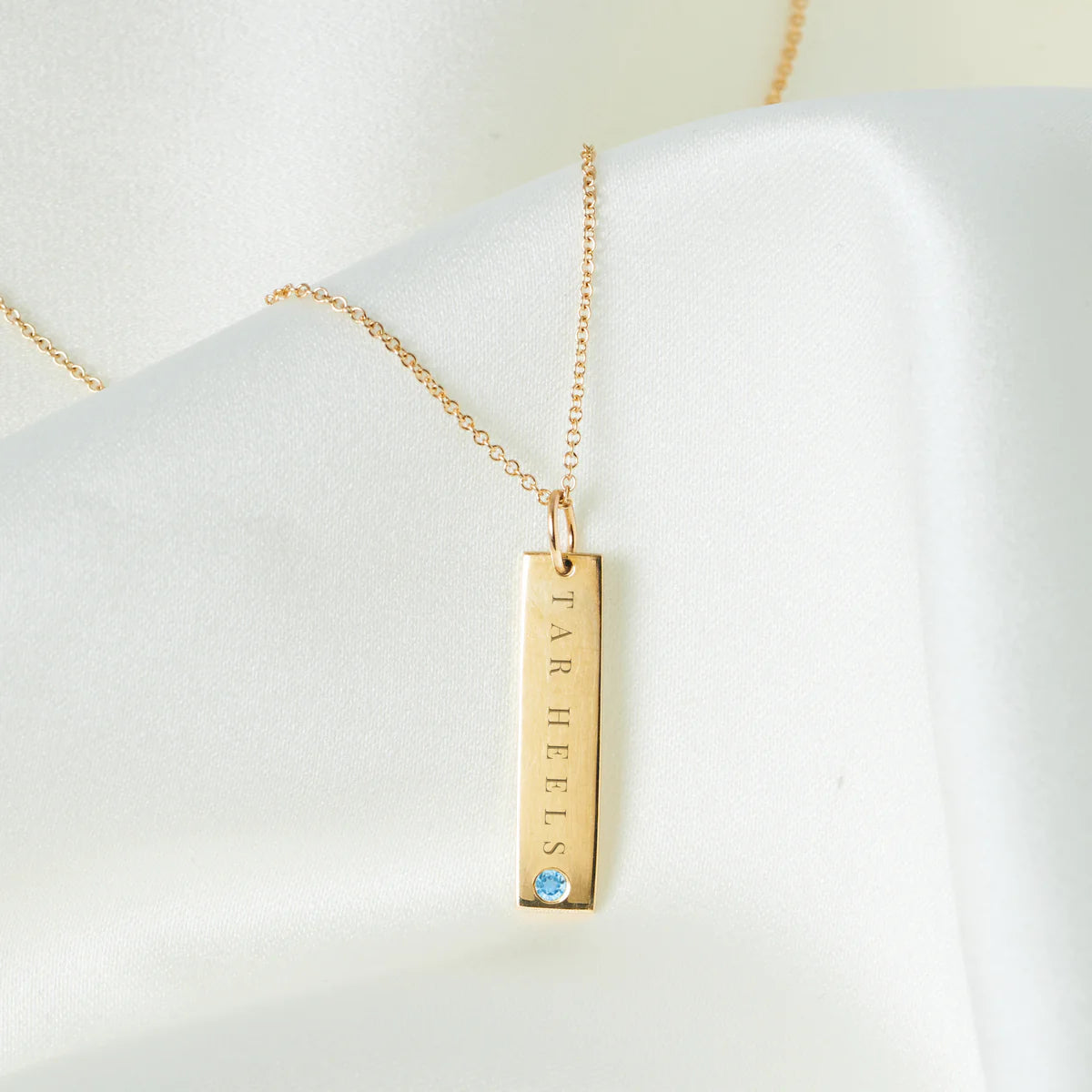 UNC Tar Heels Blue Topaz Bar in Cavan Gold - Charm Only - Lifestyle View - Kyle Cavan