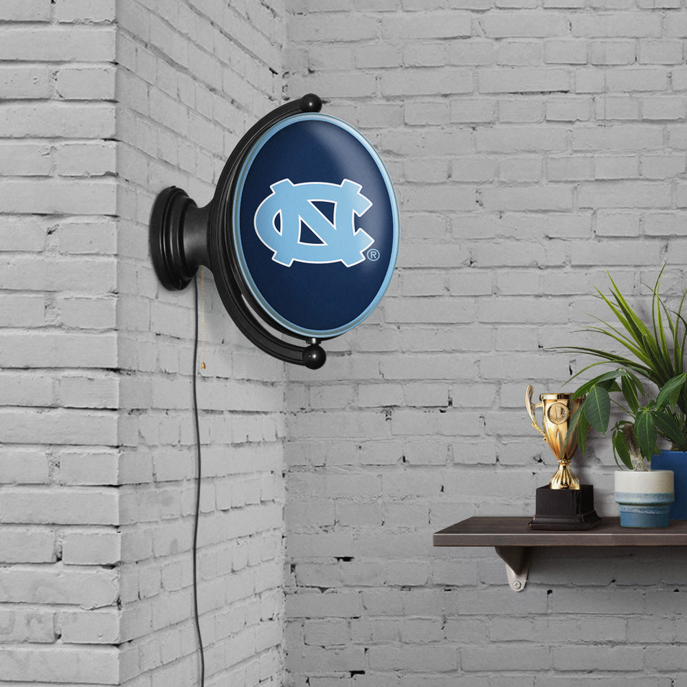 North Carolina Tar Heels: Original Oval Rotating Lighted Wall Sign Navy