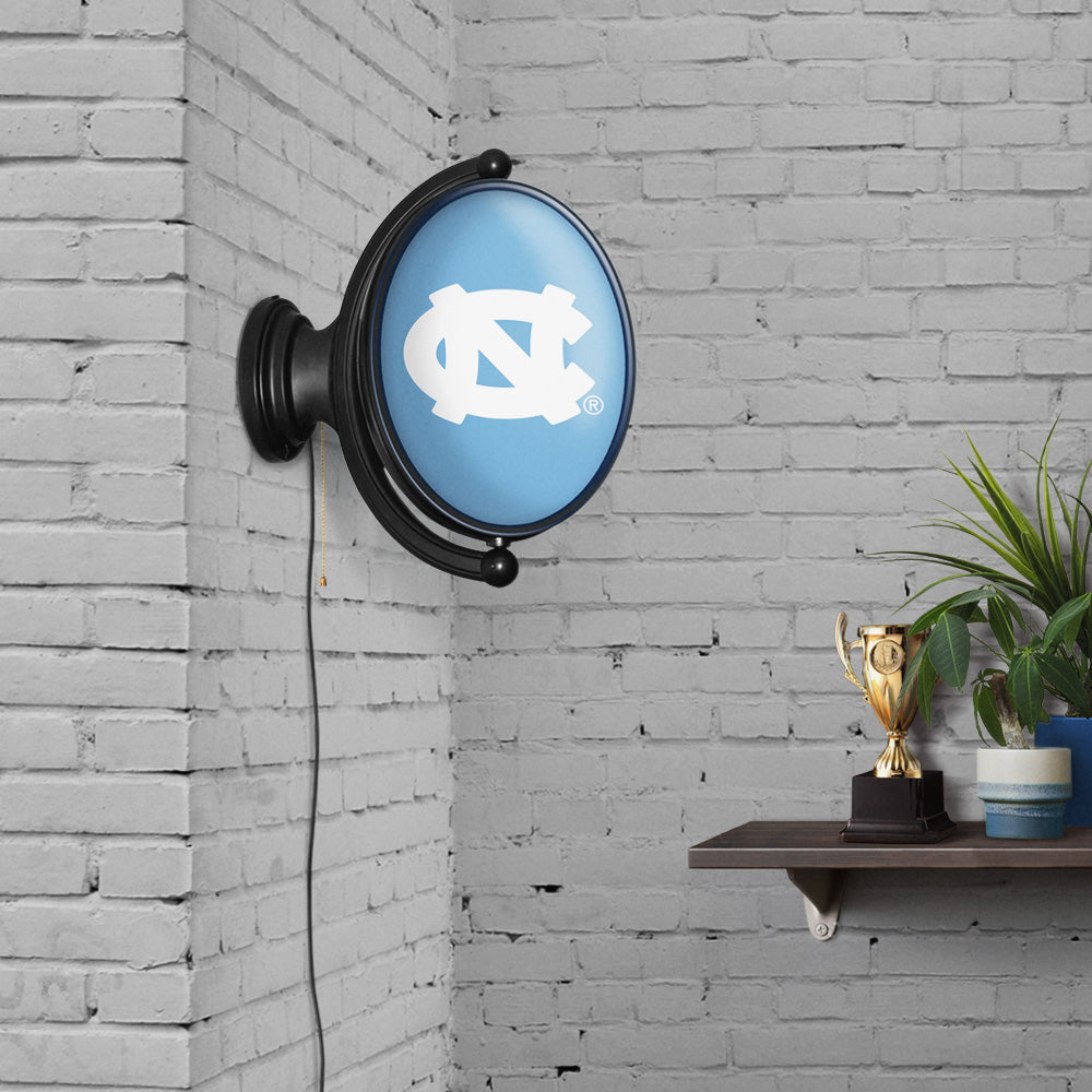 North Carolina Tar Heels: Original Oval Rotating Lighted Wall Sign Carolina Blue