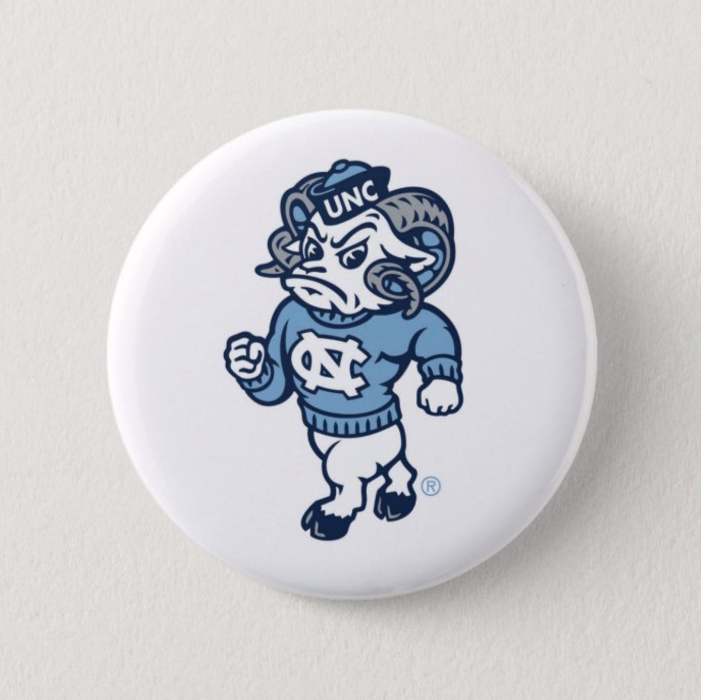 Rameses Logo Button Pin in Carolina Blue and White