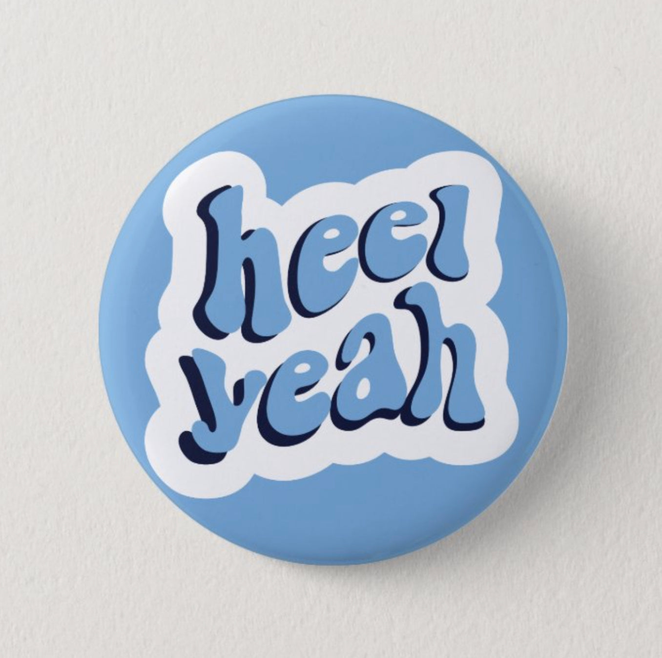 Heel Yeah Button Pin in Carolina Blue by Shrunken Head Brand