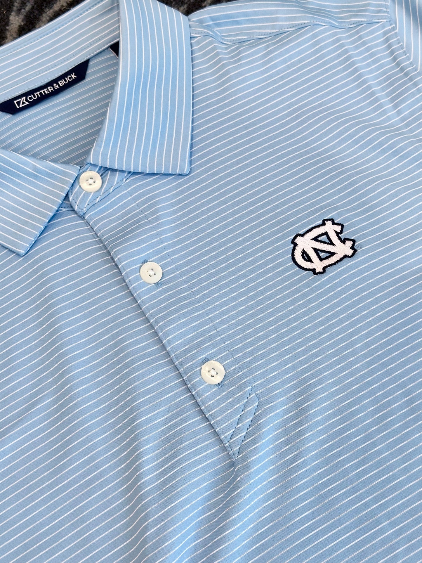 UNC Forge Eco Recycled Fine Line Stripe Polo by Cutter and Buck