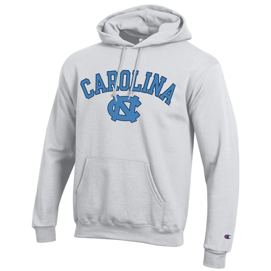A light gray pullover hoodie featuring 'CAROLINA' and the UNC logo printed in blue on the chest, with a small Champion 'C' logo on the left sleeve cuff.